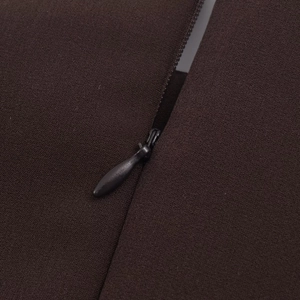 Detail view of deep brown woven fabric with a matching high-quality invisible zipper