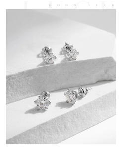 Macro shot of 925 sterling silver crown earrings featuring S925 hallmark and moissanite stones