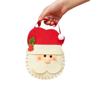Christmas Santa felt gift bag with handle for candy and holiday favors on white background