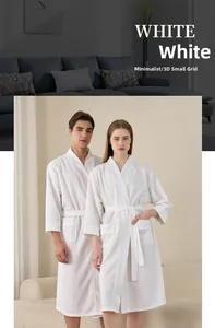 Detail showing white waffle texture fabric and pockets of a lightweight hotel bathrobe