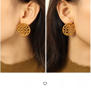 Detailed view of oversized gold plated earrings with vintage hollow mesh design
