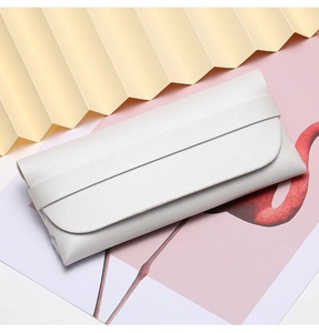 Close-up of pearl white grain leather portable sunglasses pouch with flap closure