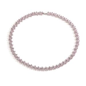 Detailed view of silver necklace with pink crystal flower links on a white background