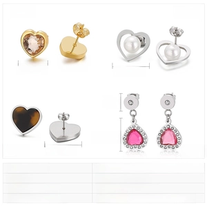 Detailed view of heart-shaped earrings with rhinestones, pearls, and tortoiseshell patterns