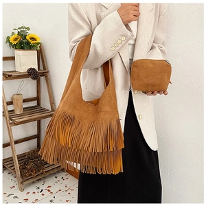 Close-up of brown faux suede fringe tote bag and matching zippered storage pouch set