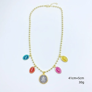 Detail of beaded gold chain necklace with five colorful religious Virgin Mary pendants
