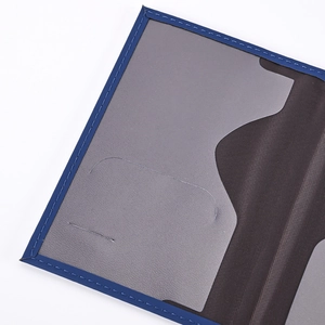 Detail showing blue stitching and internal grey card slots of the world map passport holder