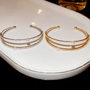 Double-layer open bracelet with sparkling cubic zirconia and elegant white pearls