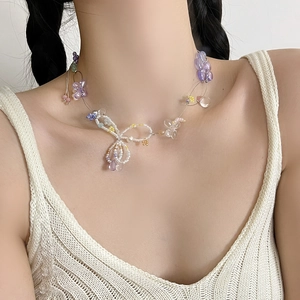 Floral beaded necklace with colorful crystal flowers and pearls worn by a model
