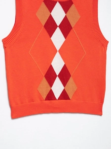 Detail of knit argyle vest showing orange fabric texture and ribbed elastic hem