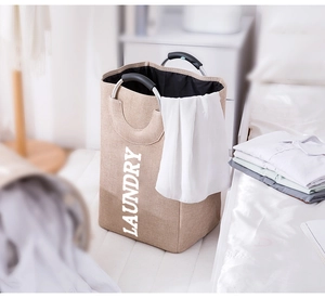 Detail of round aluminum handles with soft black padding on khaki laundry basket