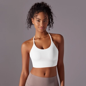 Front view of a white halter neck sports bra with thin straps and wide hem for yoga wear