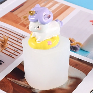 Detail of unicorn silicone mold with finished white and purple resin unicorn figure