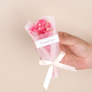 Mini dried baby's breath bouquet in pink wrap with Eternal love tag and beige ribbon bow