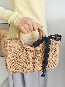 Handmade straw handbag with black lace bow detail for summer beach vacations