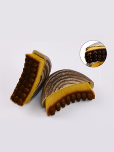 Close-up of crescent foundation brush with dual-layer bristles and ergonomic wood grain handle