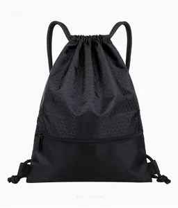 Macro shot of waterproof black nylon backpack showing honeycomb texture and front zipper