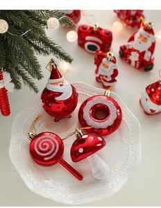 Festive Santa and donut Christmas ornaments displayed in a decorative white lace plate
