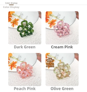 Detailed view of hollow five-petal flower hair claws with rhinestones in four colors