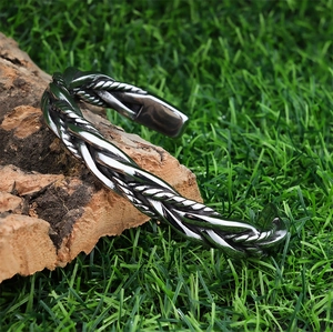 Nordic woven C-shaped open bangle in polished stainless steel for a vintage metallic look