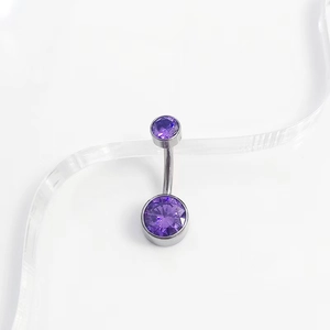 Macro detail of G23 titanium belly ring featuring double purple zircon stone inlay