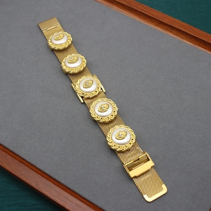 Vintage gold mesh bracelet with five round relief charms and sparkling crystals