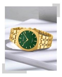 Detailed close-up of CURREN square quartz watch with green dial and golden metal strap