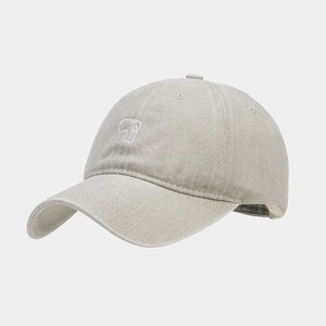 Detail of vintage washed baseball cap featuring white line embroidery and soft crown texture