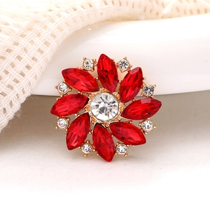 Red marquise stone floral brooch with gold base and sparkling white crystals