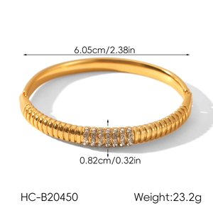 Detailed view of 18k gold plated stainless steel bangle with four rows of inlaid crystals