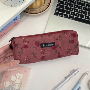 Detail of vintage floral corduroy pencil case with secure zipper and brand woven label
