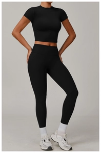 Close-up of black high-elasticity yoga set with cropped short sleeve and high waist leggings