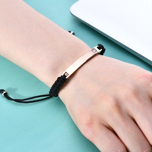 Minimalist 7mm braided rope bracelet with rose gold bar and pink gemstone on mint background
