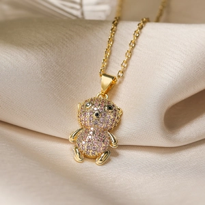 Gold plated teddy bear pendant necklace with pink and black zircon on silk fabric