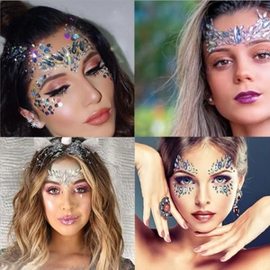 Close-up of sparkling face rhinestones and glitter stickers for festival makeup looks