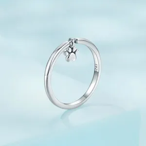 S925 sterling silver ring featuring a cute dangling dog paw pendant on a blue background