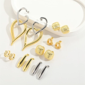 Collection of oversized heart pendants and trendy vintage metal earrings in gold and silver