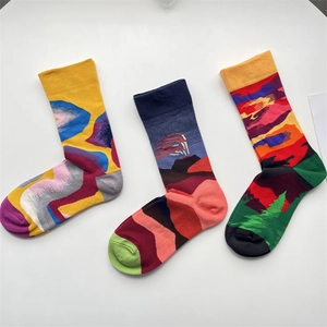 Artistic mid-calf cotton socks with colorful abstract jacquard patterns on white background