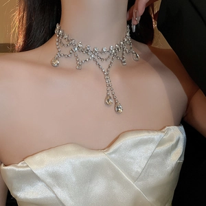 Detailed view of silver choker with sparkling zircon tassels and teardrop crystal pendants