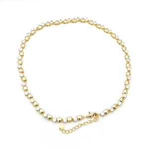 Detailed view of heart-shaped links and white cubic zirconia with gold lobster clasp