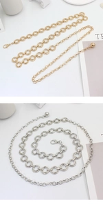 Close-up of gold and silver circular link chain belts with adjustable lobster clasp