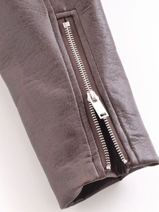 Detailed macro view of the brown PU leather jacket cuff featuring a silver metal zipper