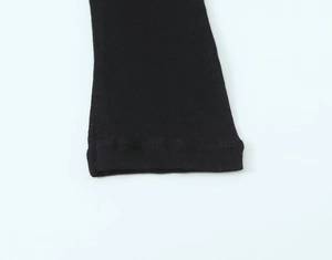 Close-up of black ribbed knit cotton cuffs on a long sleeve high neck fashion top