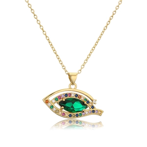 Detail view of gold evil eye pendant with green marquise stone and multi-colored crystals