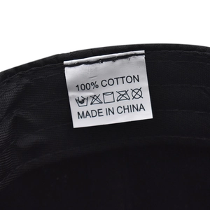 Close-up of the 100% cotton washing label inside the black quick-dry outdoor cap