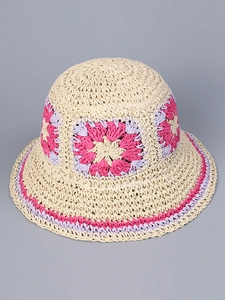 Detailed top view of handmade crochet straw hat featuring pink floral woven patterns