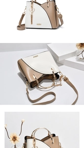 Macro view of color-block leather bag with gold ZZMY logo and heart tassel detail