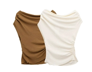 Detail showing asymmetric off-shoulder design and ruched texture on slim fit tops