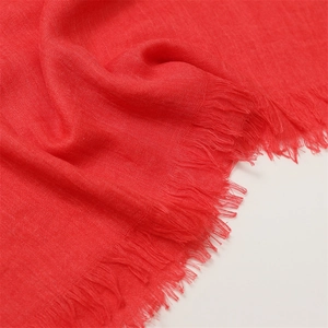 Detail shot of red cotton linen scarf showing woven texture and fringe tassel edge