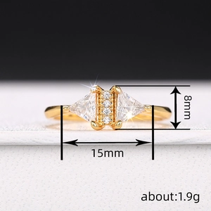 Gold triangle geometric ring with cubic zirconia stones featuring 8mm by 15mm dimensions